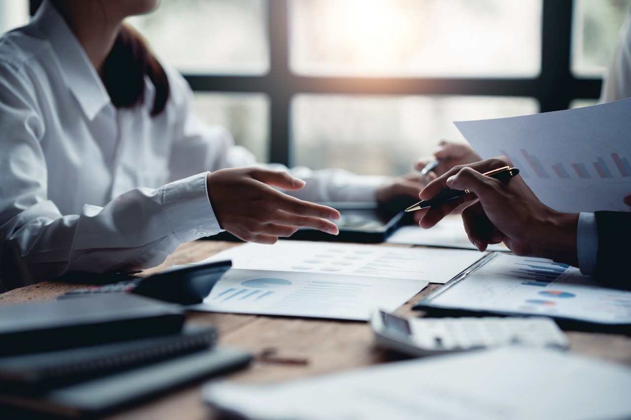 close up of professionals writing on a notebook